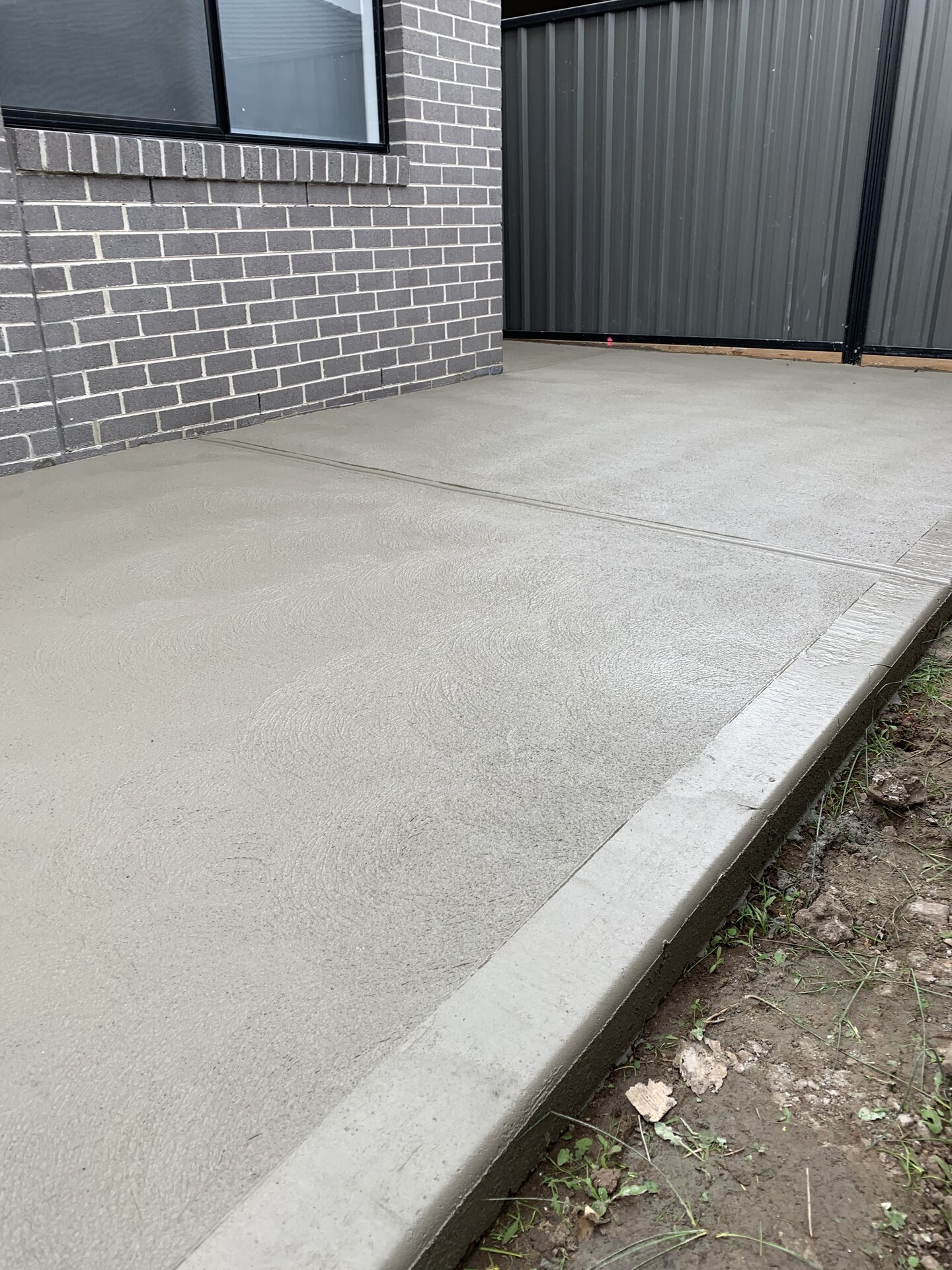 Fresh concrete path alongside house
