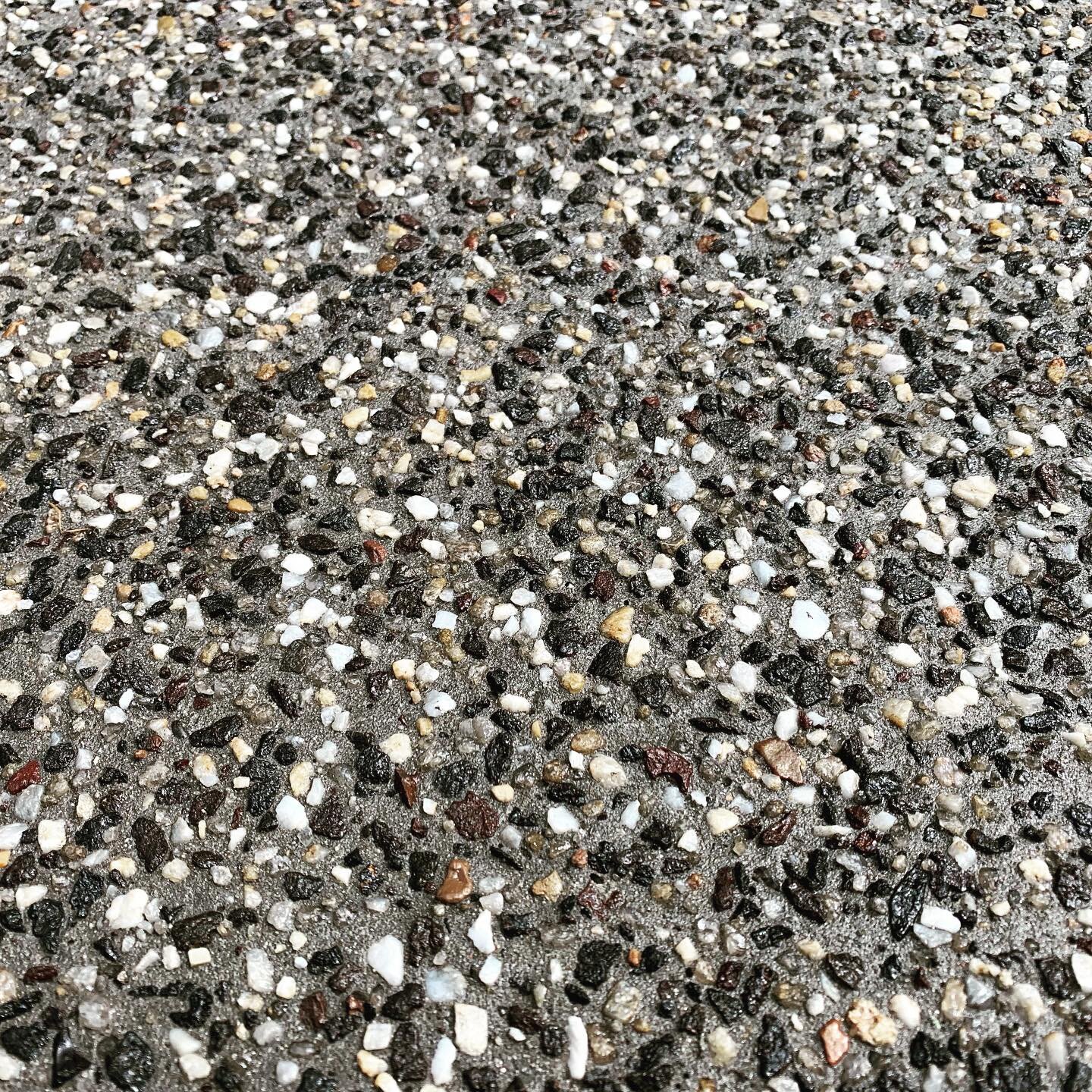 Exposed aggregate concrete texture close-up
