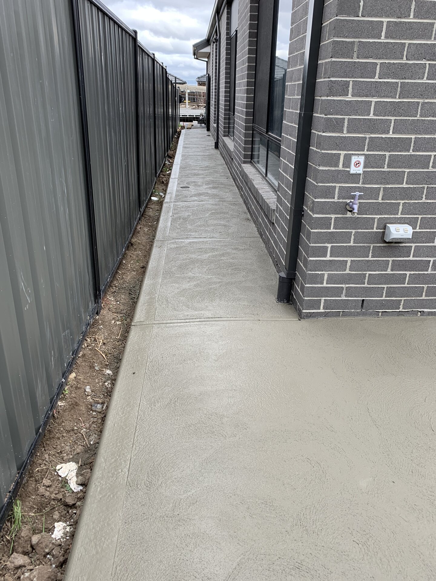 Concrete driveway beside house